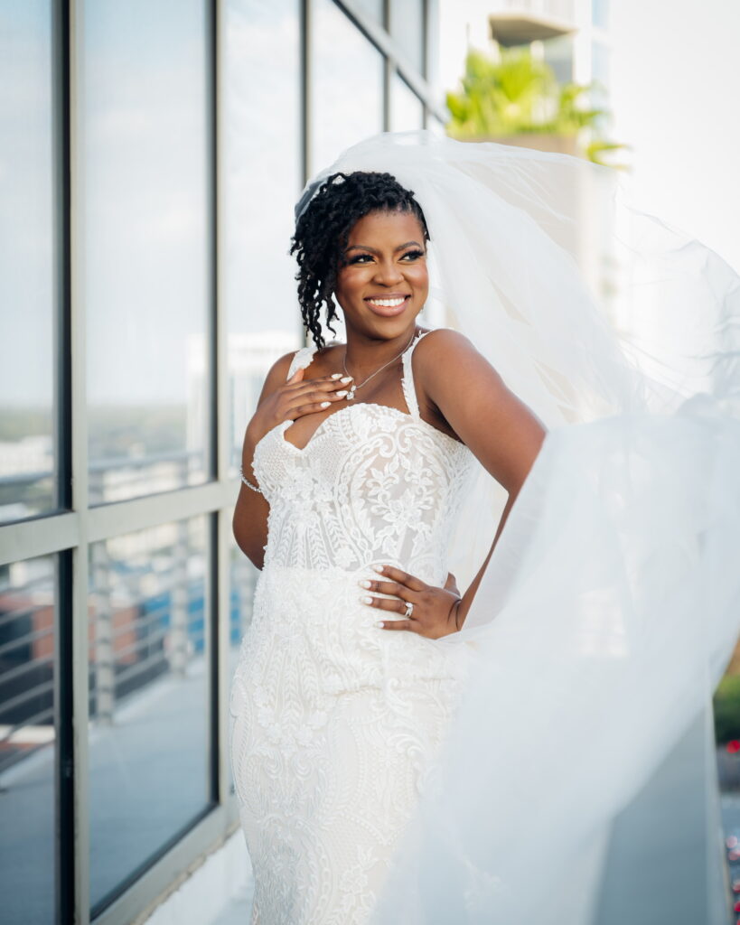 Black and hite image of a black bride with a veil on a balcony